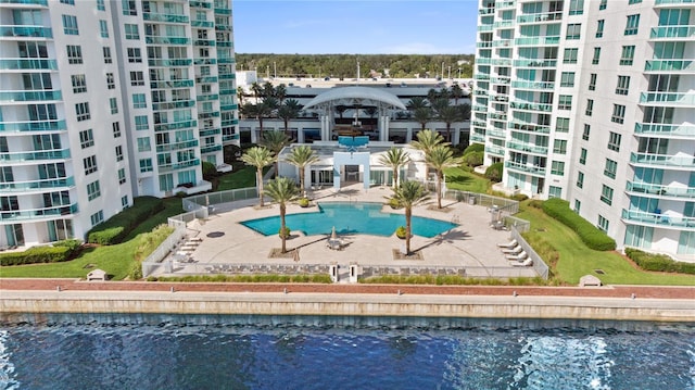 view of swimming pool with a patio and a water view