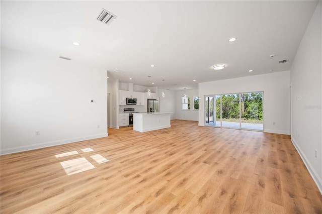 unfurnished living room with light hardwood / wood-style floors