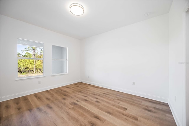 spare room with hardwood / wood-style floors