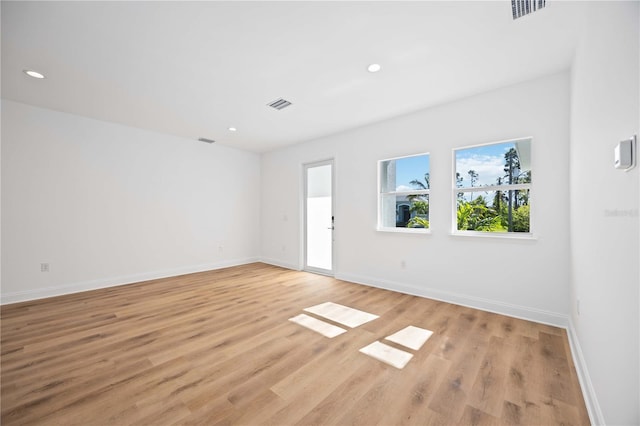 spare room featuring light hardwood / wood-style floors