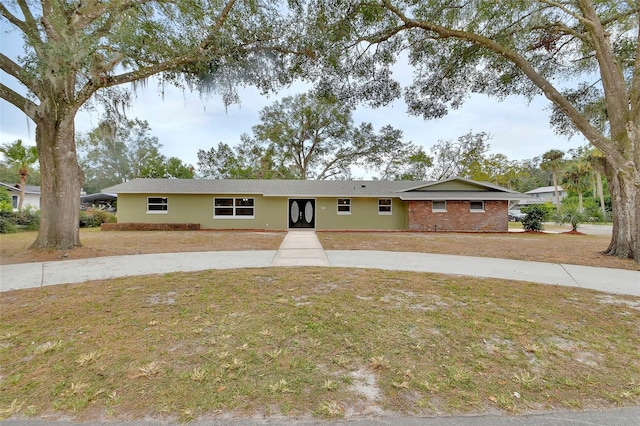 ranch-style home with a front lawn