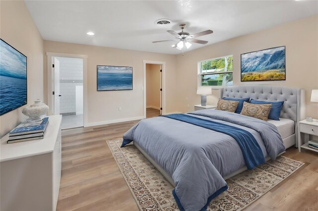 bedroom with connected bathroom, ceiling fan, and light wood-type flooring