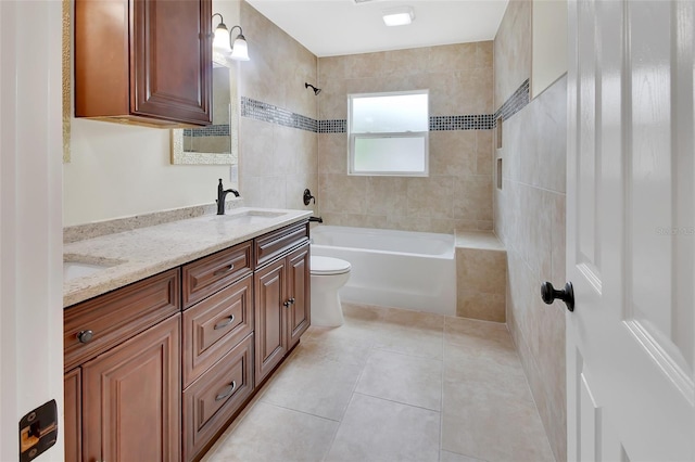 full bathroom with toilet, vanity, tile patterned floors, and tiled shower / bath