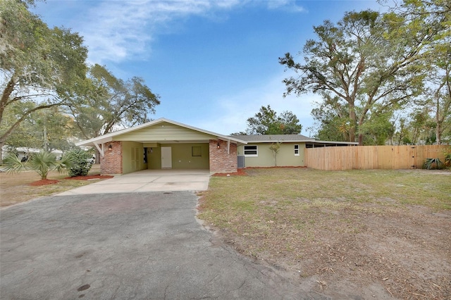 ranch-style house featuring a front yard and a carport