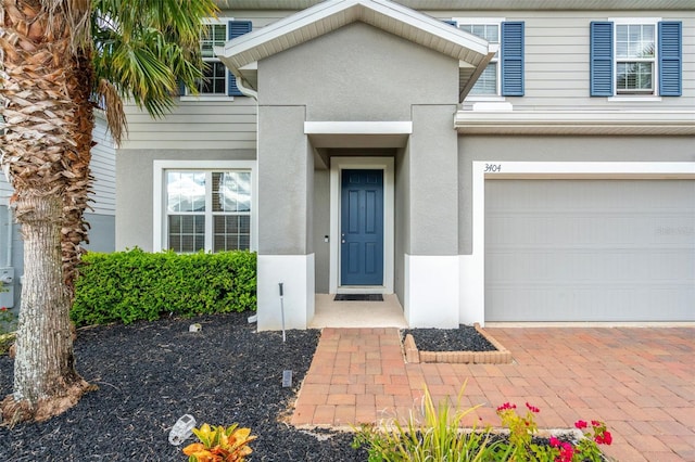 view of exterior entry featuring a garage