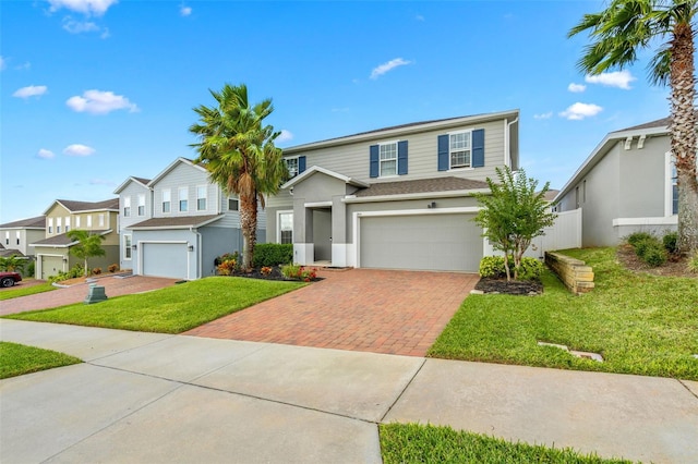 front of property with a garage and a front lawn