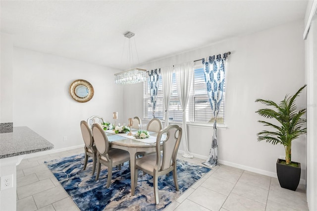 tiled dining area with a chandelier