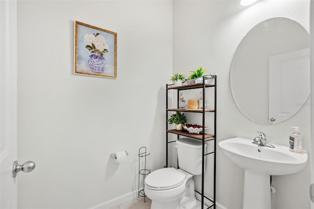 bathroom with tile patterned floors, toilet, and sink