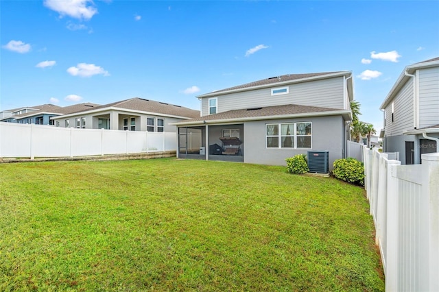 back of house with a sunroom, central AC unit, and a yard