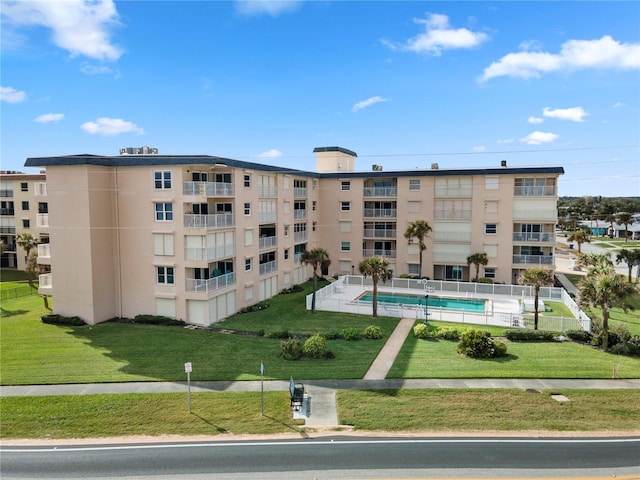 view of building exterior featuring a community pool