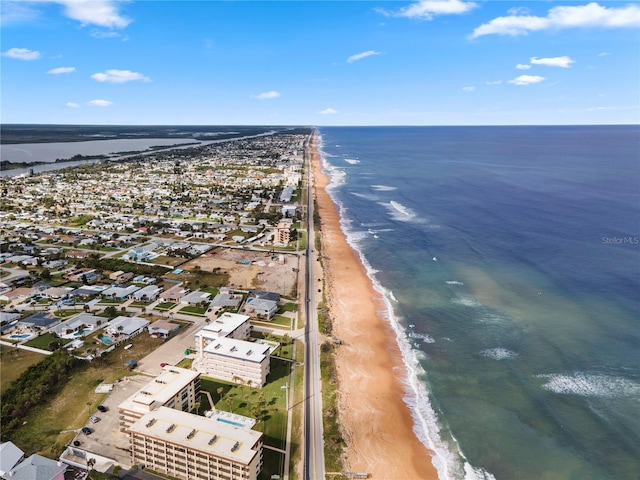 drone / aerial view with a water view and a view of the beach