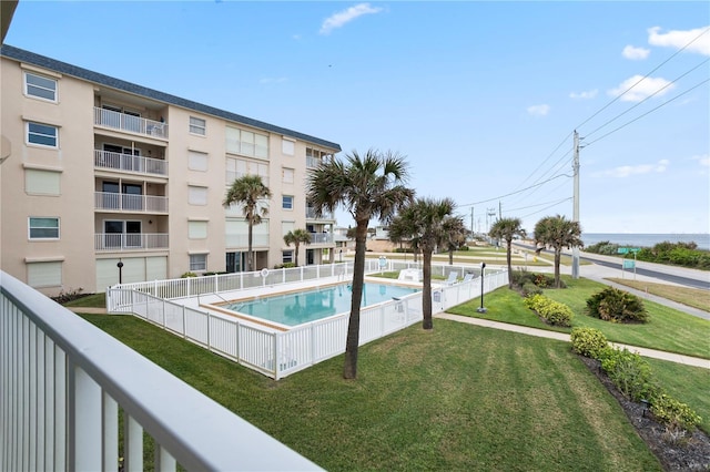 view of pool featuring a lawn