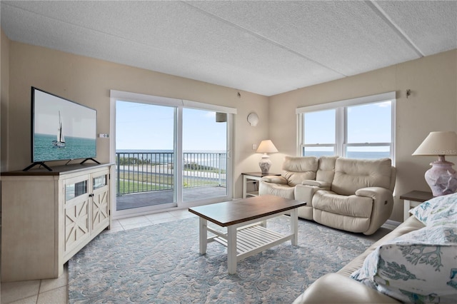 living room featuring light tile patterned flooring and a textured ceiling