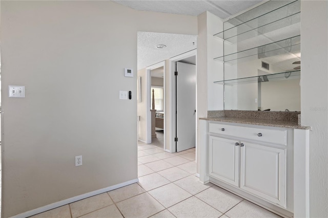 hallway with light tile patterned floors