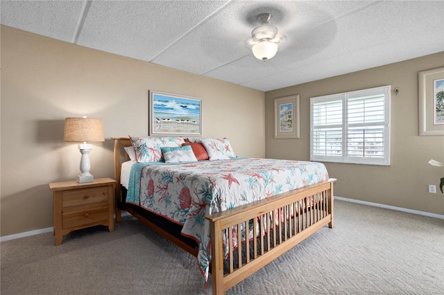 bedroom featuring carpet flooring, ceiling fan, and a textured ceiling