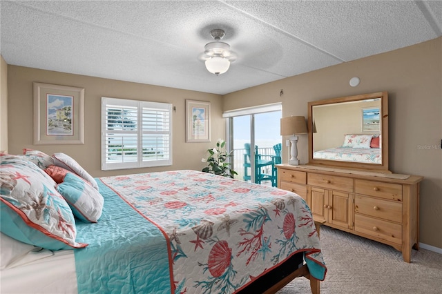 bedroom featuring access to exterior, ceiling fan, light colored carpet, and multiple windows