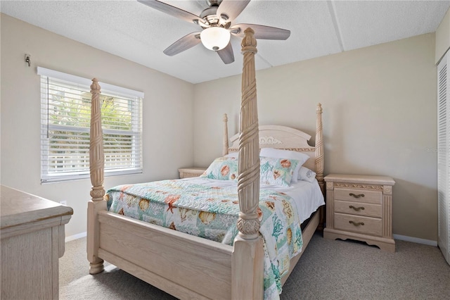 bedroom with light carpet, a textured ceiling, and ceiling fan