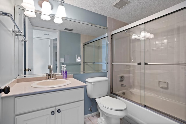 full bathroom with shower / bath combination with glass door, vanity, a textured ceiling, and toilet