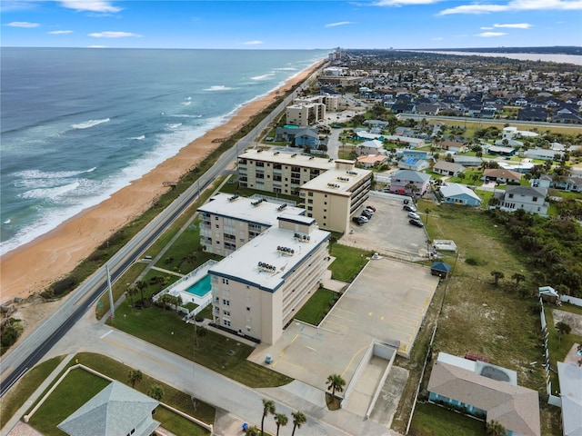 drone / aerial view with a beach view and a water view