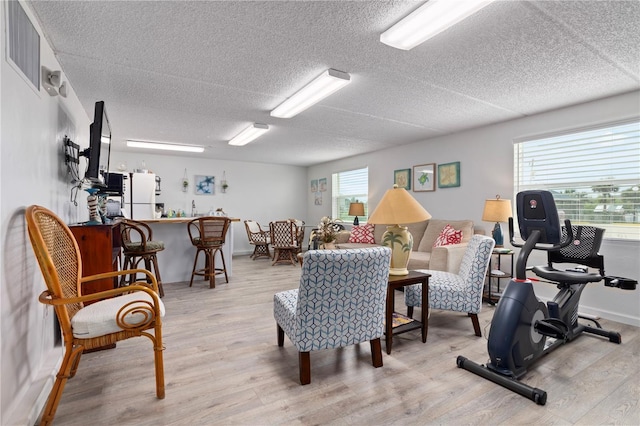 interior space featuring a textured ceiling and light wood-type flooring