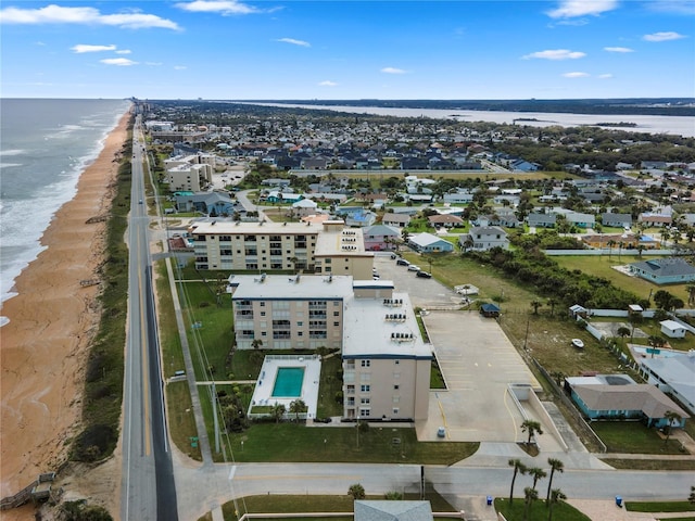 drone / aerial view with a beach view and a water view