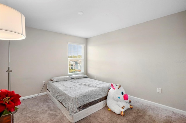 bedroom featuring light carpet