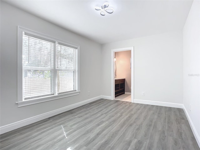 unfurnished room with light wood-type flooring