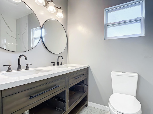 bathroom with tile patterned floors, vanity, and toilet