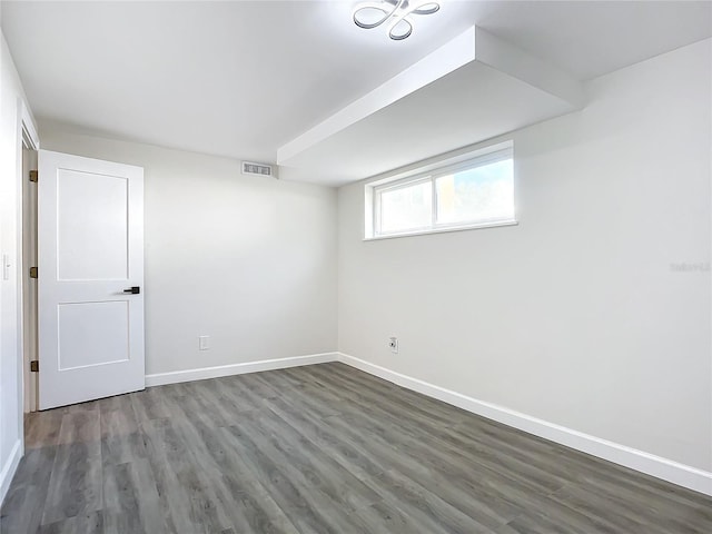 basement with dark hardwood / wood-style flooring