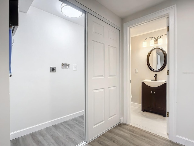 bathroom featuring vanity, hardwood / wood-style flooring, and toilet