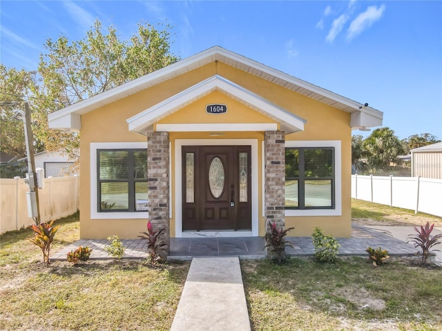 doorway to property with a lawn