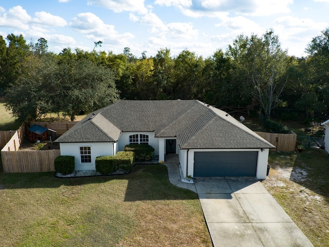 single story home featuring a front lawn and a garage