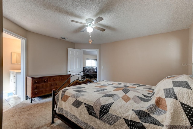 bedroom with light carpet, a textured ceiling, and ceiling fan