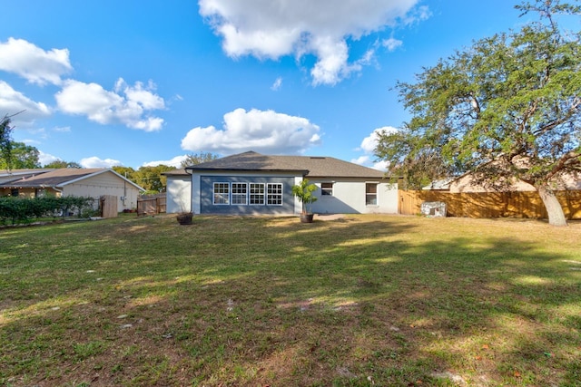 back of house with a yard