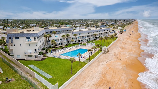 birds eye view of property featuring a water view and a beach view