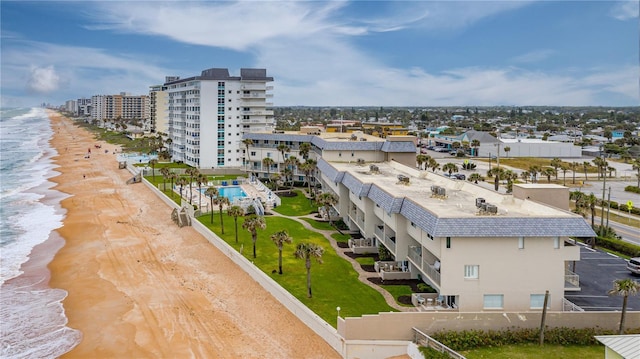 bird's eye view featuring a water view and a beach view