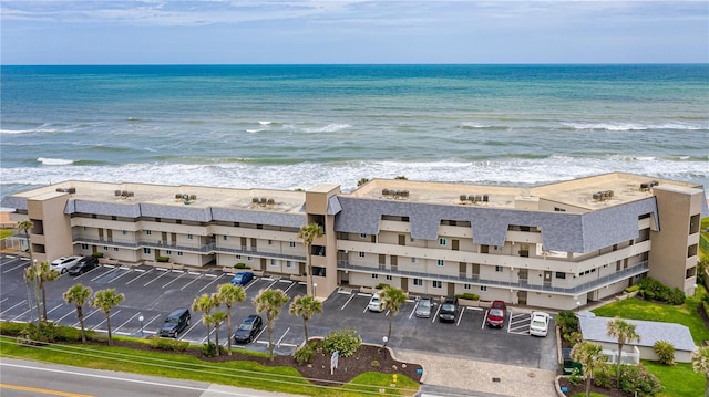 bird's eye view featuring a water view and a beach view