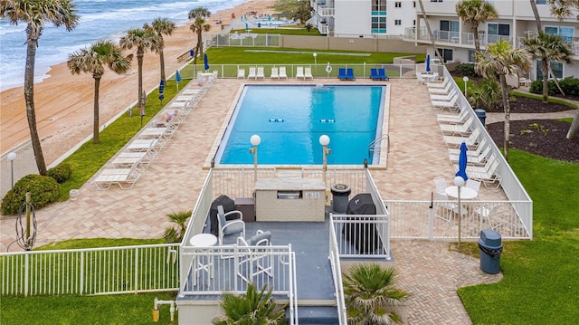 view of pool featuring a water view and a patio