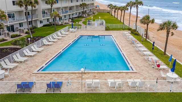 view of swimming pool with a patio and a water view