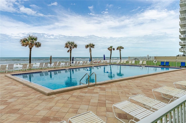 view of pool with a water view