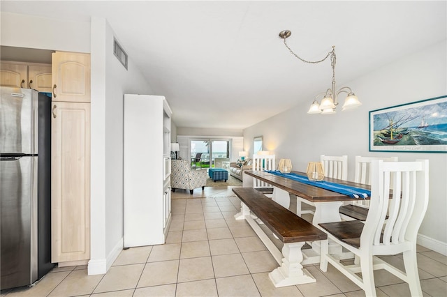 tiled dining area with an inviting chandelier