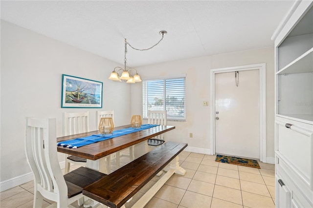 dining space featuring light tile patterned floors and a notable chandelier