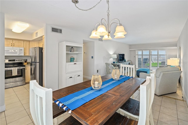 tiled dining space with a notable chandelier