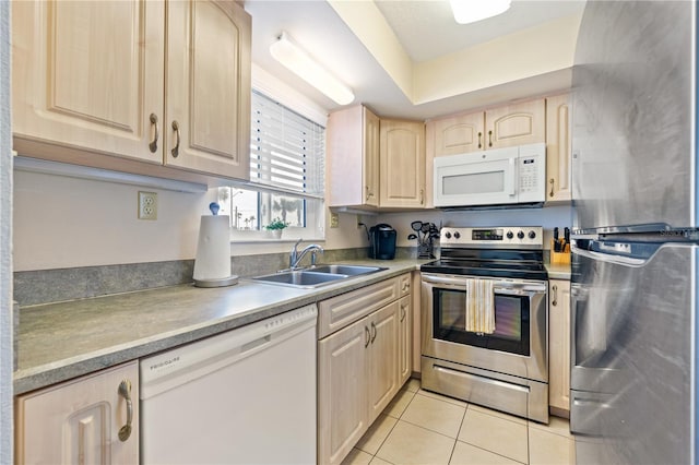 kitchen featuring sink, light tile patterned floors, stainless steel appliances, and light brown cabinetry