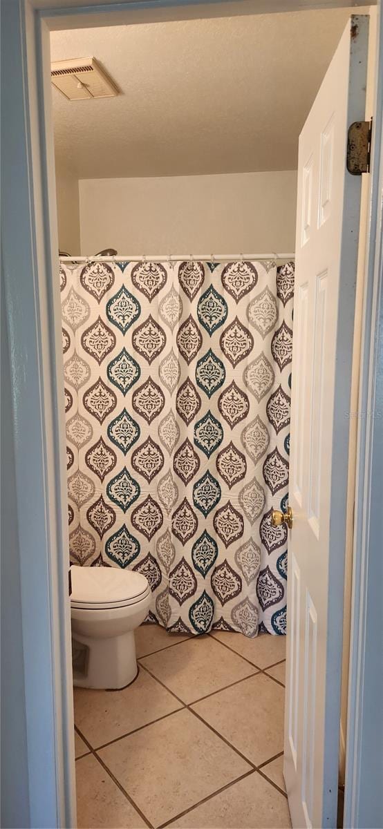 bathroom with tile patterned floors and toilet