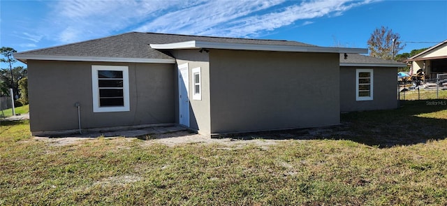 back of house with a lawn