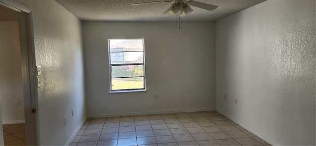 unfurnished room featuring light tile patterned floors, a textured ceiling, and ceiling fan