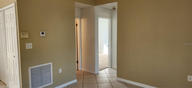 hall with light tile patterned floors