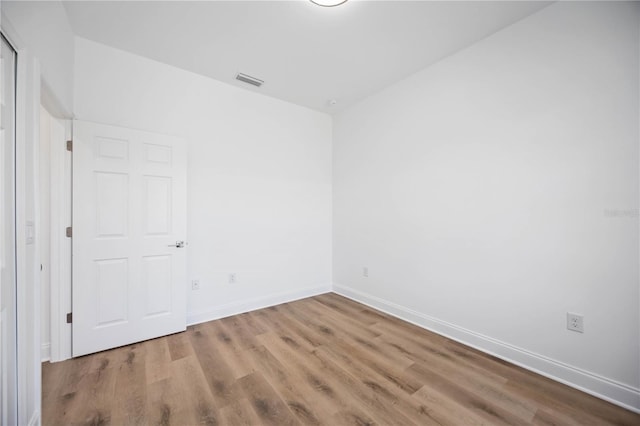 spare room with wood-type flooring