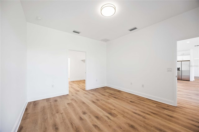 spare room with light hardwood / wood-style floors